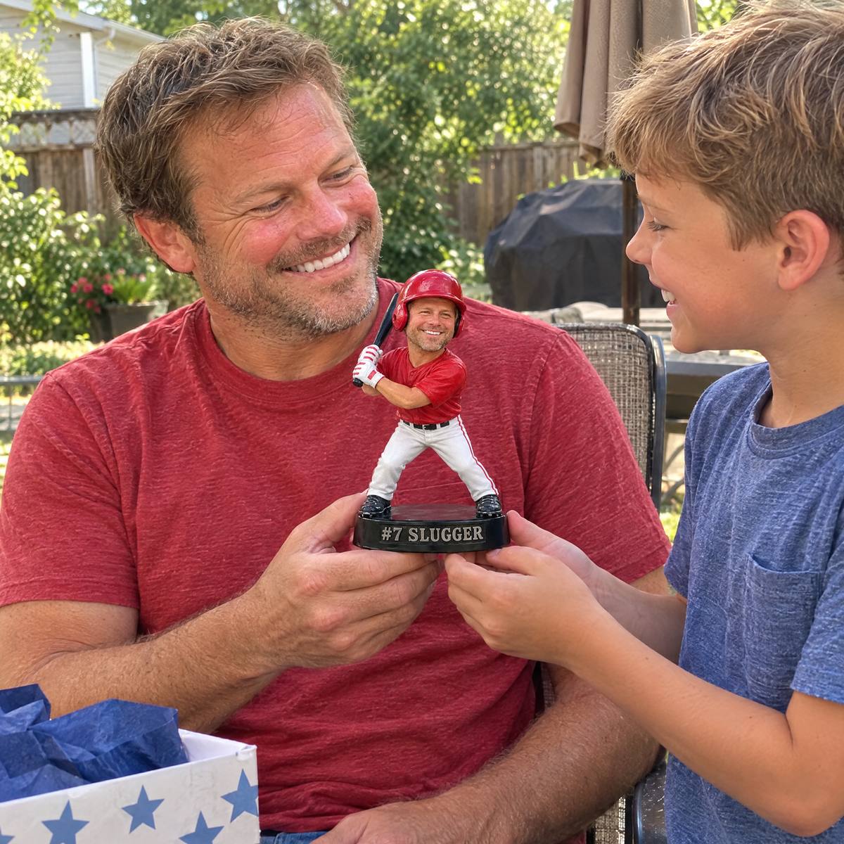 His son gives him the baseball batter figurine on Father's Day in the backyard