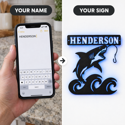 Typed name HENDERSON on phone next to finished shark LED sign