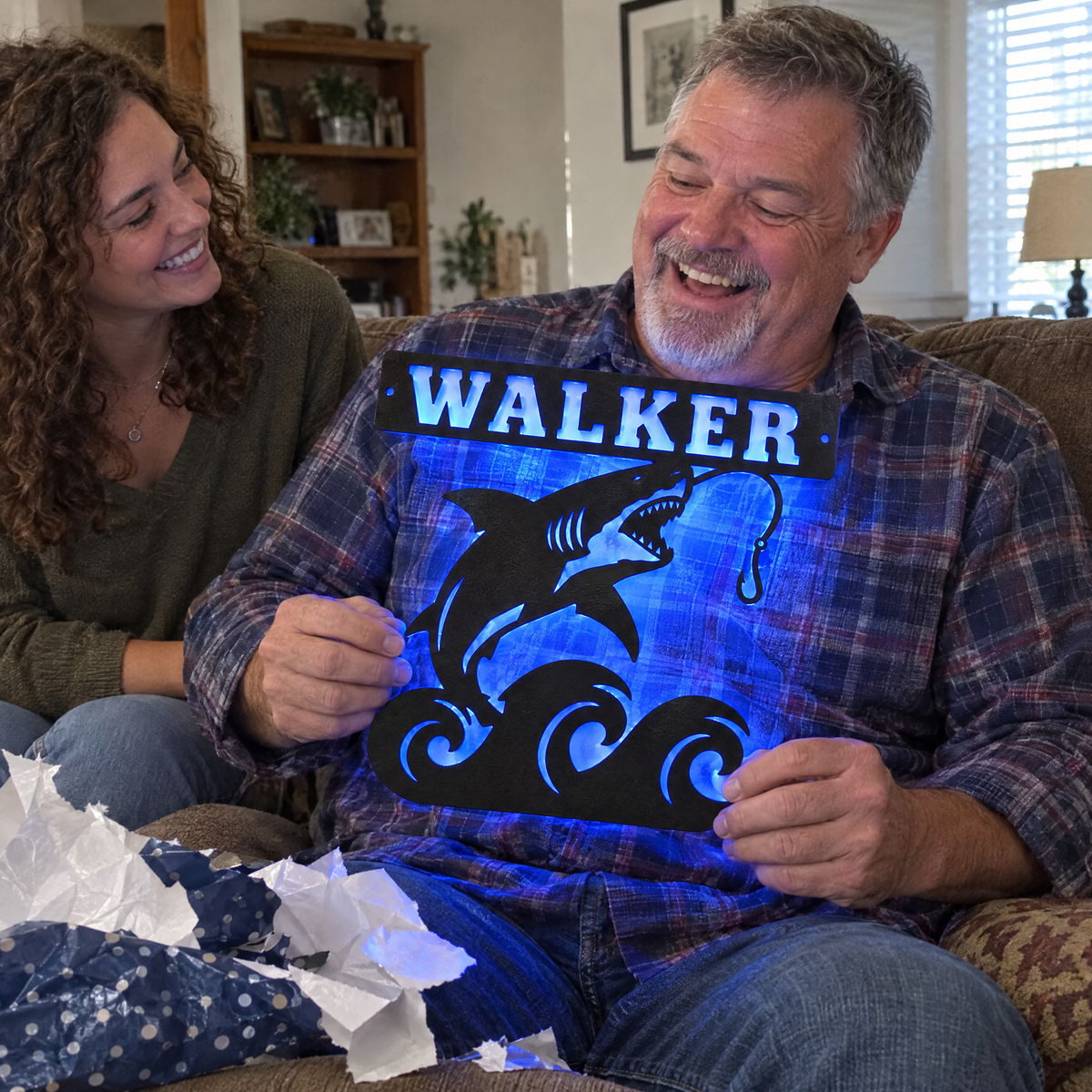 Daughter gives dad a lit shark name sign on Father's Day