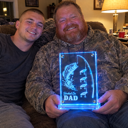 Dad with son holding glowing Hooked On DAD mirror light on Father's Day