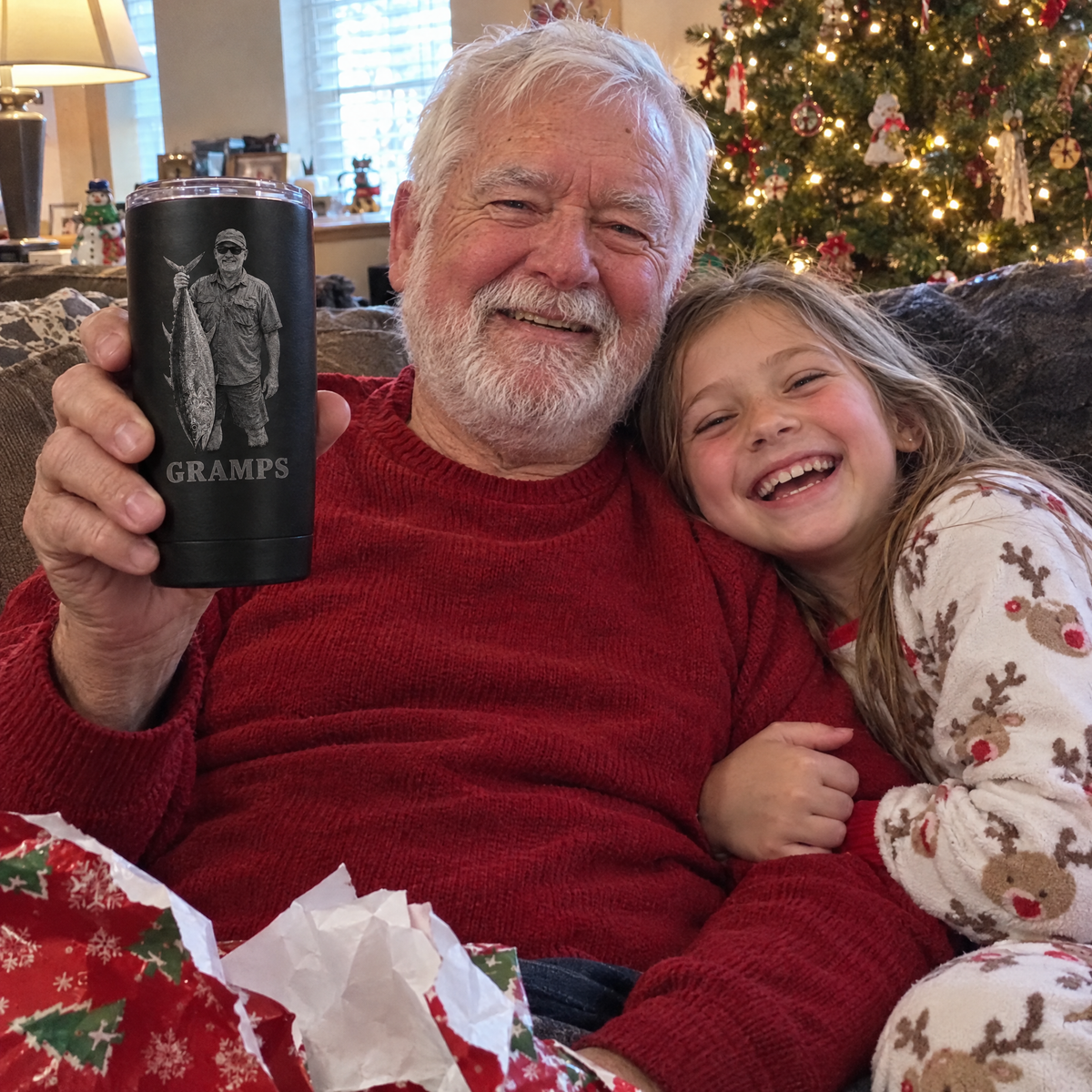 Grandpa holds engraved GRAMPS tumbler with granddaughter at Christmas