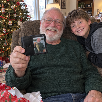 Grandpa shows his fishing photo wallet at Christmas with grandson