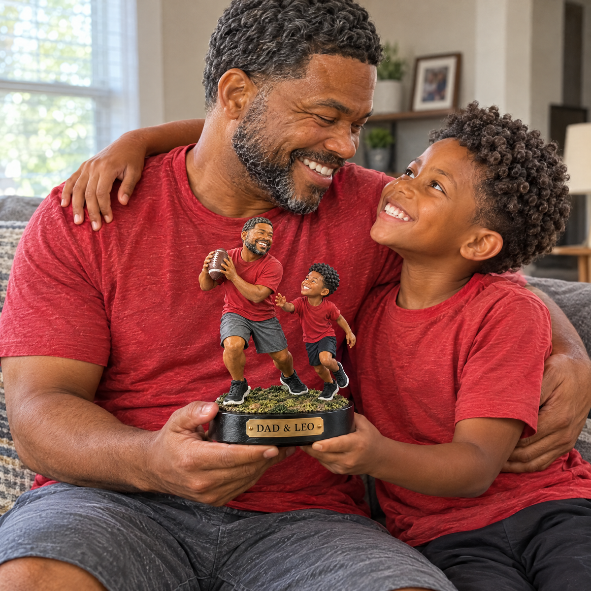 The son gives his dad the father and son football figurine on Father's Day