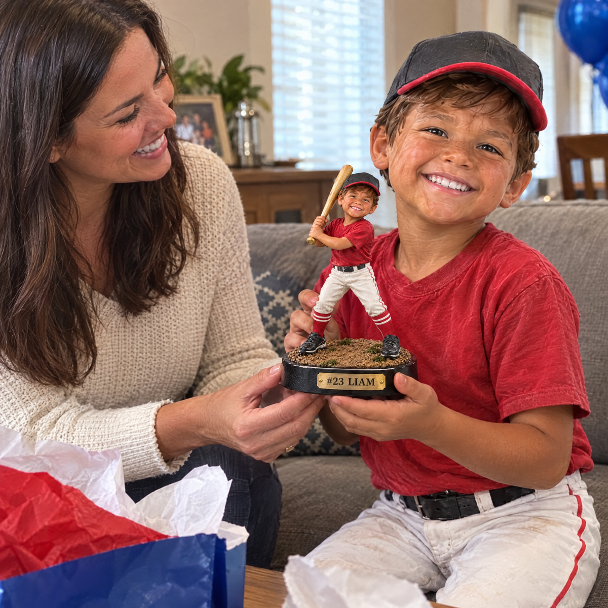 Mom gives her son the Little League player figurine at the end-of-season party