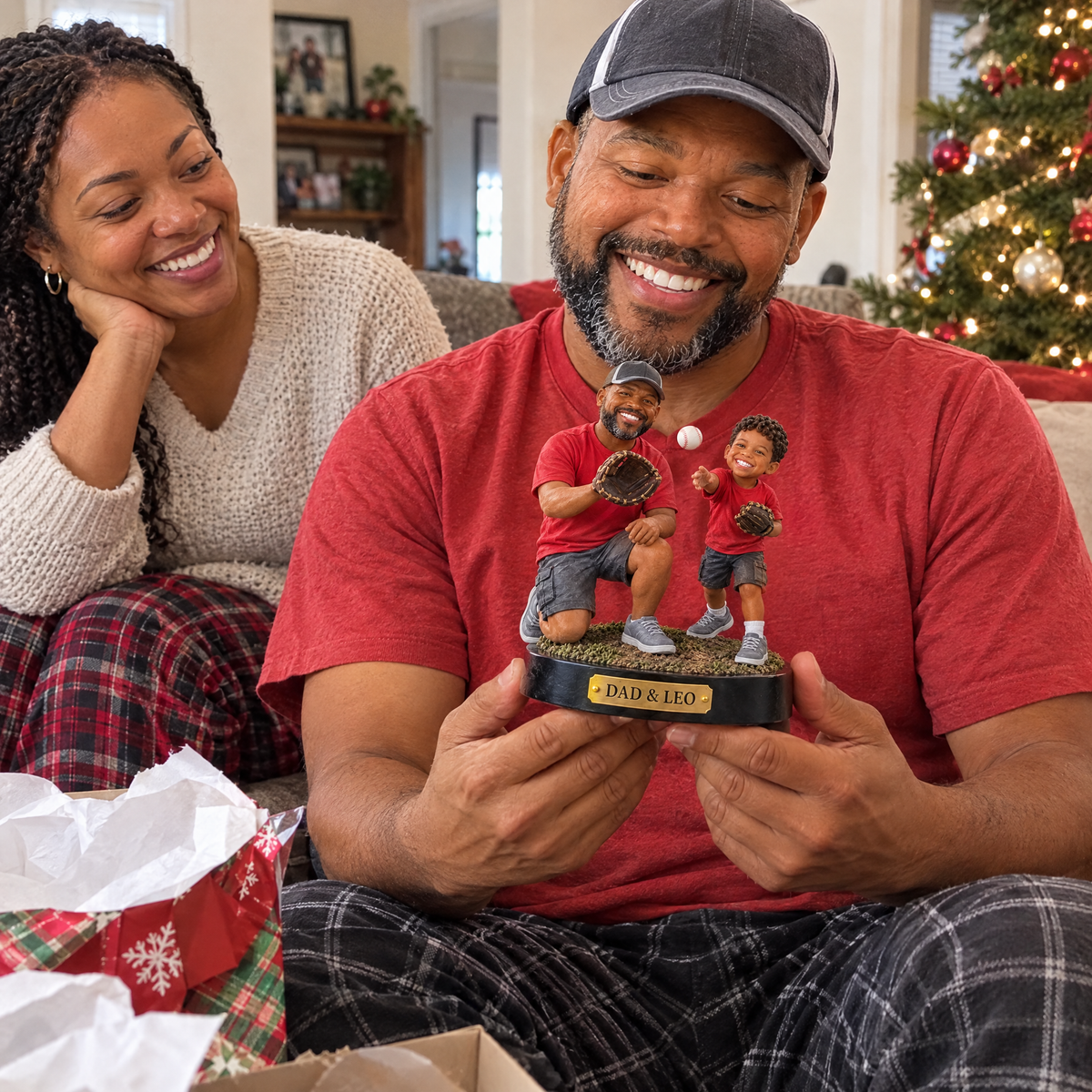 Mom watches dad unwrap the father and son baseball figurine at Christmas