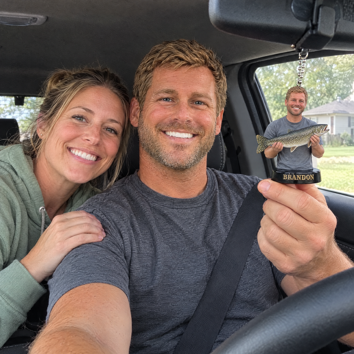 Husband hangs his custom big catch car charm on birthday