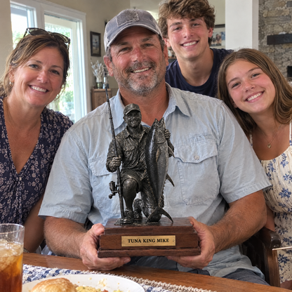 Dad holds BEST DAD fishing statue at Father's Day brunch