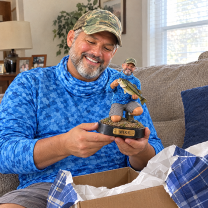 Dad unwrapping his custom fishing figurine gift