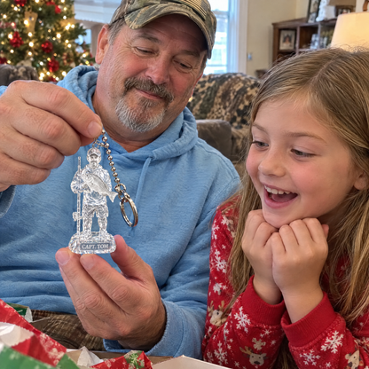 Grandpa shows crystal fishing keychain to granddaughter at Christmas